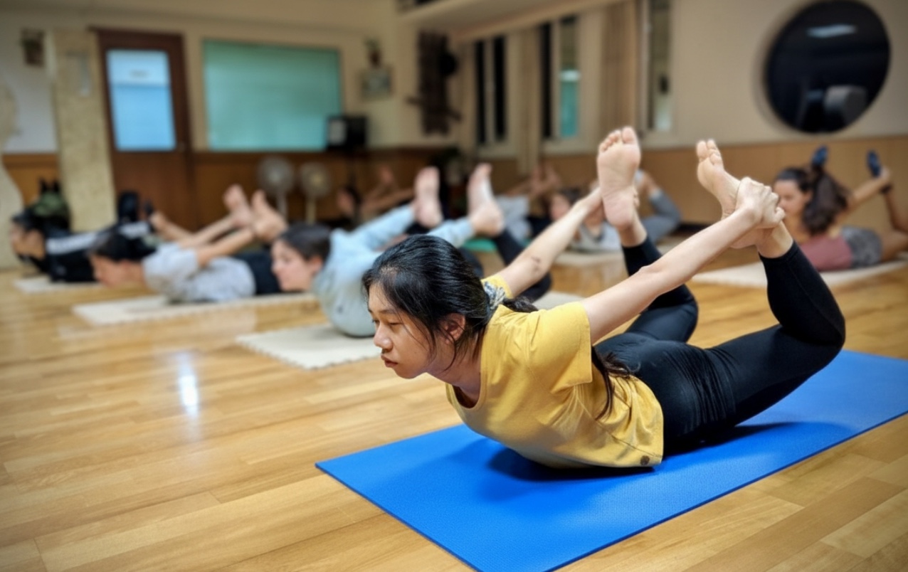 Students practising yoga asanas together at the Tainan centre
